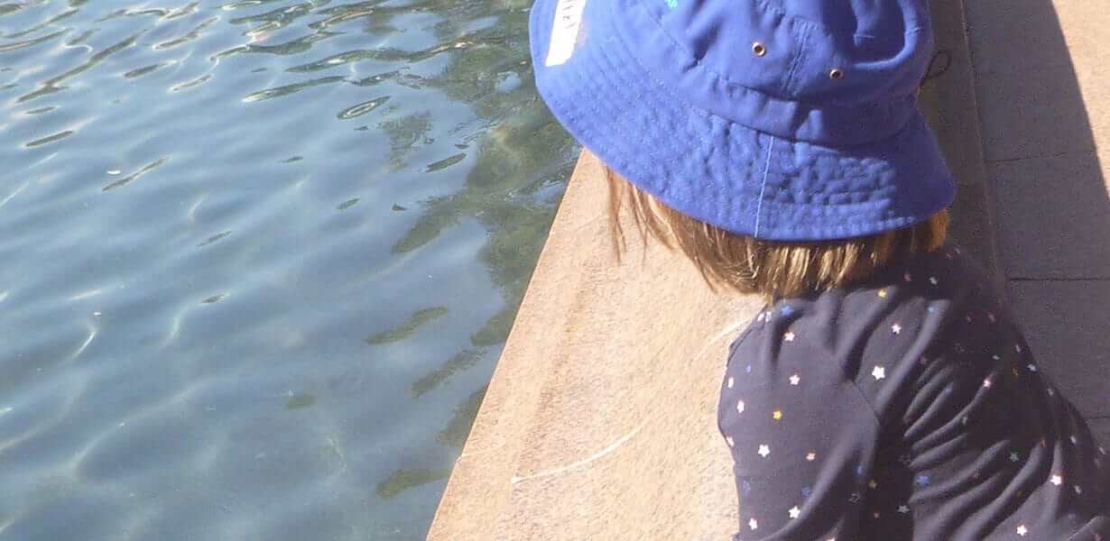 Child from Guardian Margaret St looking out at water in park