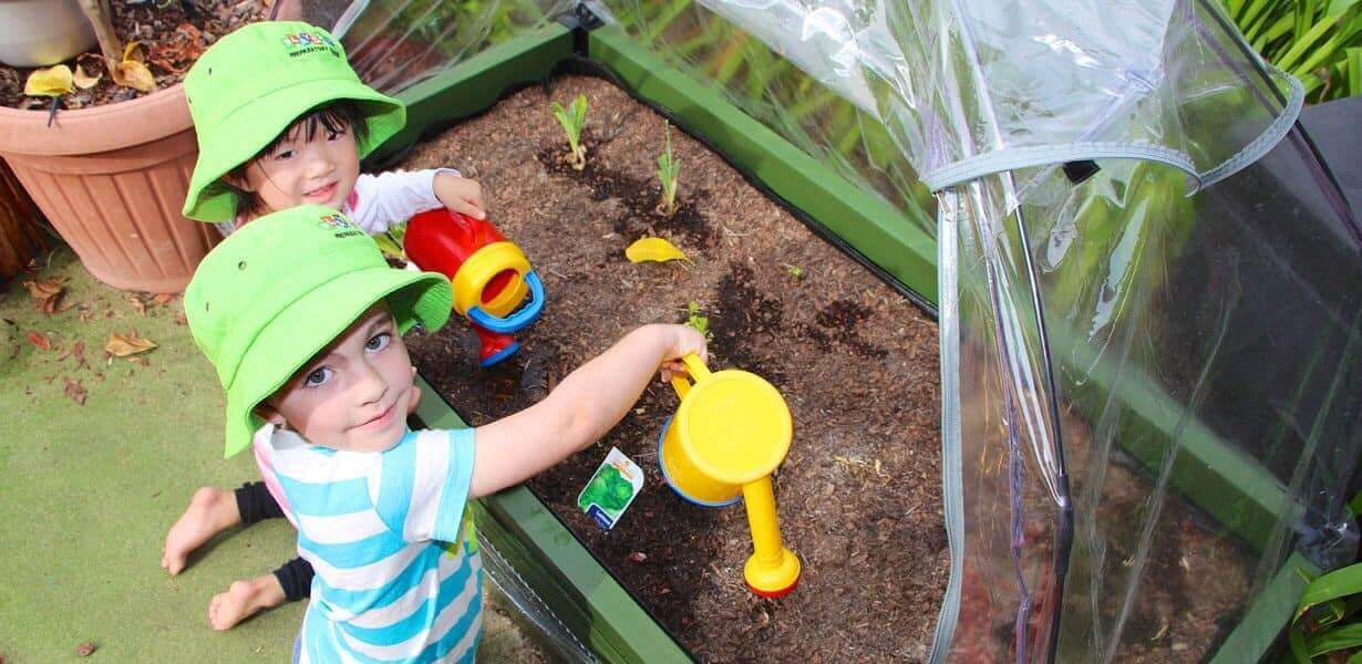 2 children watering plants at Guardian West Pennant Hills