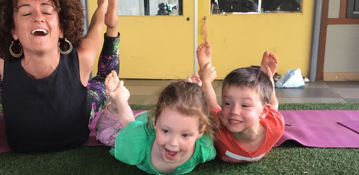 Educator and two children doing Yoga at Guardian St Kilda South