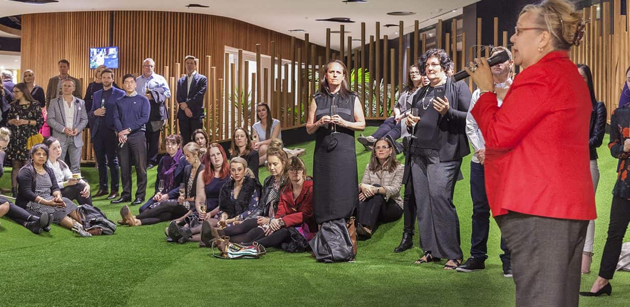 Educators seated on centre fake grass