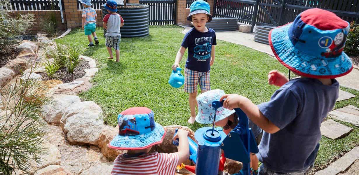 Children playing outdoor with water fountain