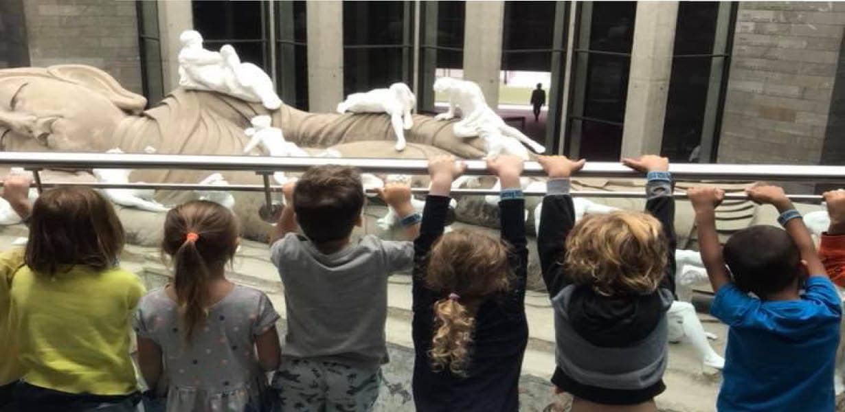 Children examining a sculpture at the National Gallery of Victoria.