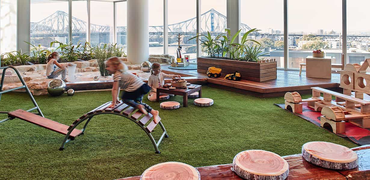 children playing in rooftop playground at Guardian Queen St