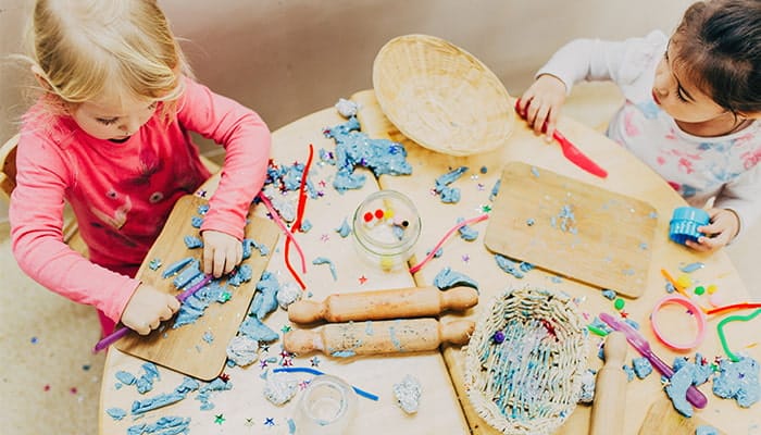 Two children playing with arts and craft