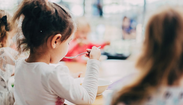 child eating at first week of childcare