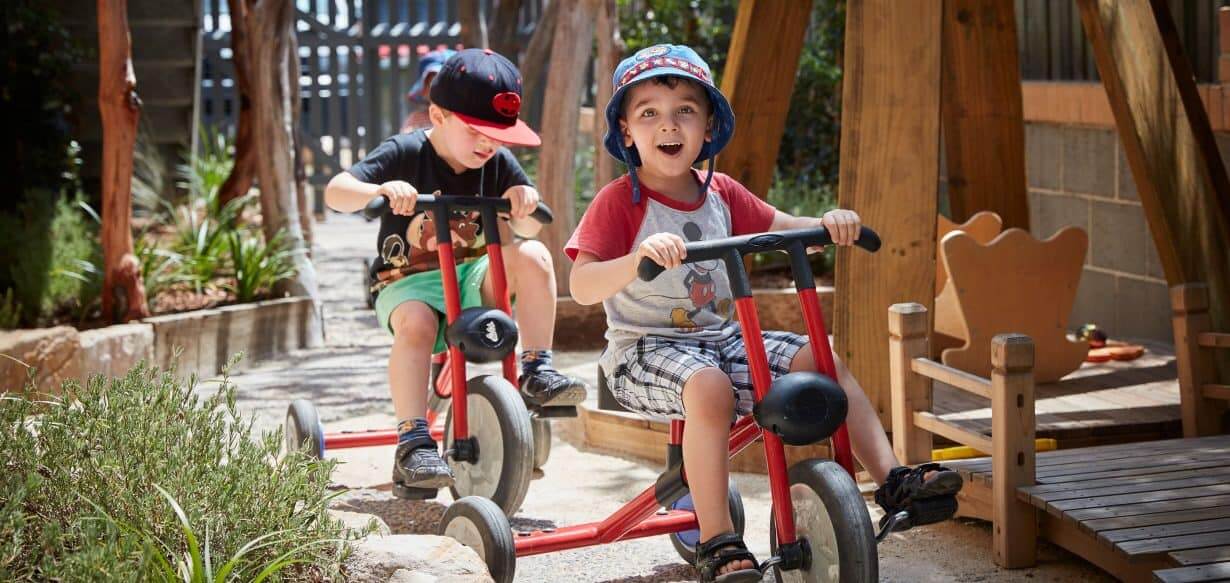 children riding bikes at childcare participating in active play