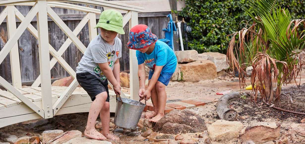 children playing outdoors with water at Blackburn Village