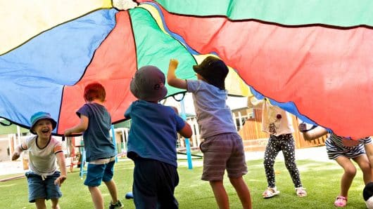 children running under parachute at Lizards ELC