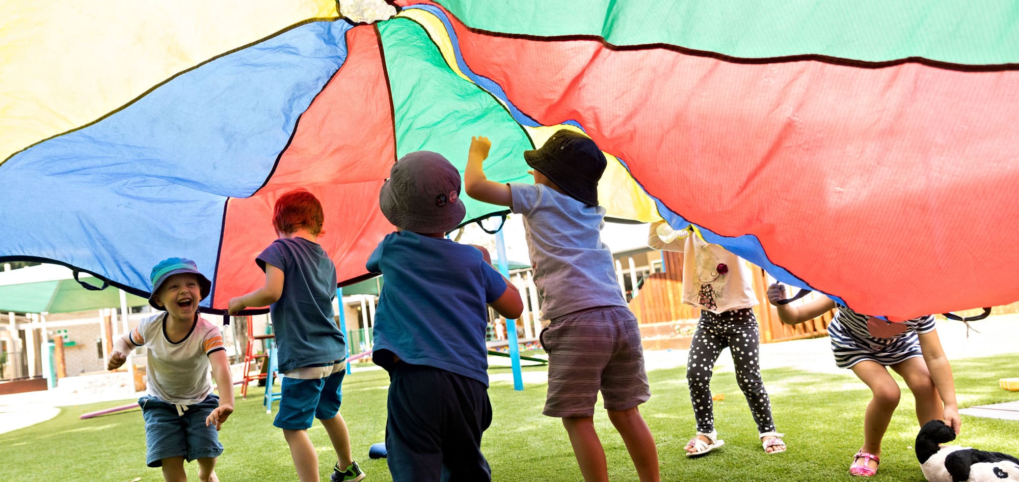 children running under parachute at Lizards ELC