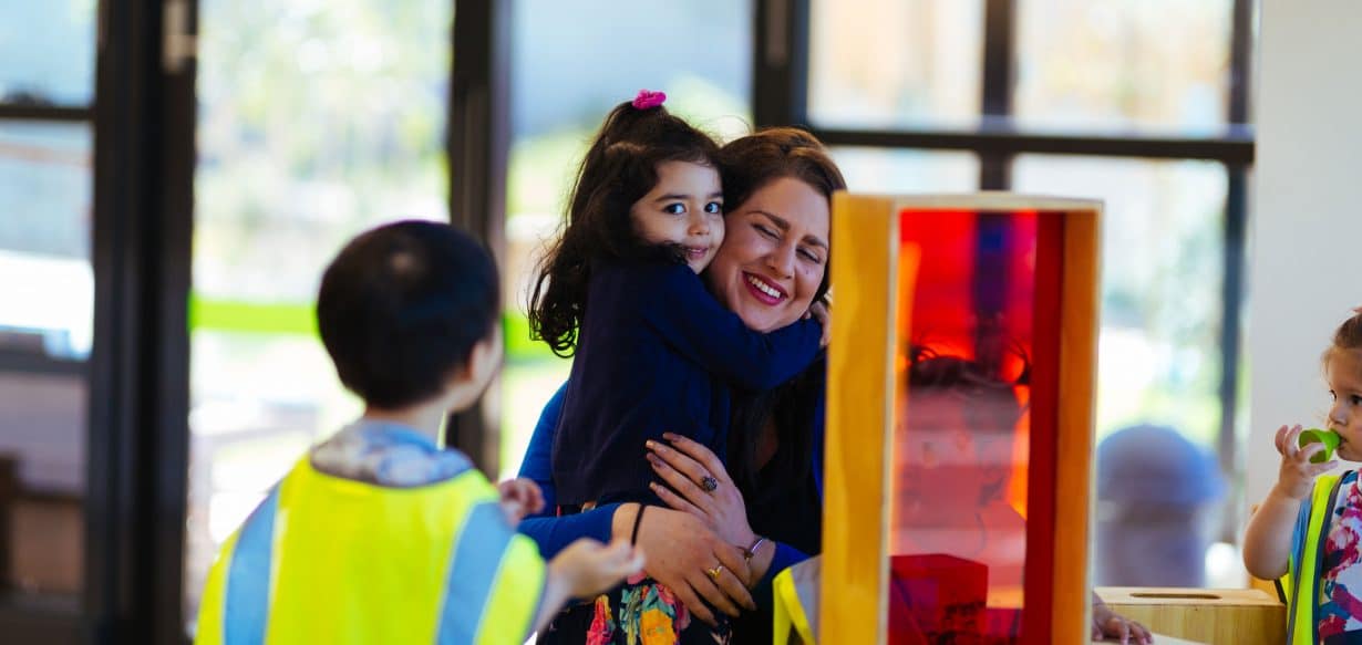 Alyce hugging child at Mulgrave centre