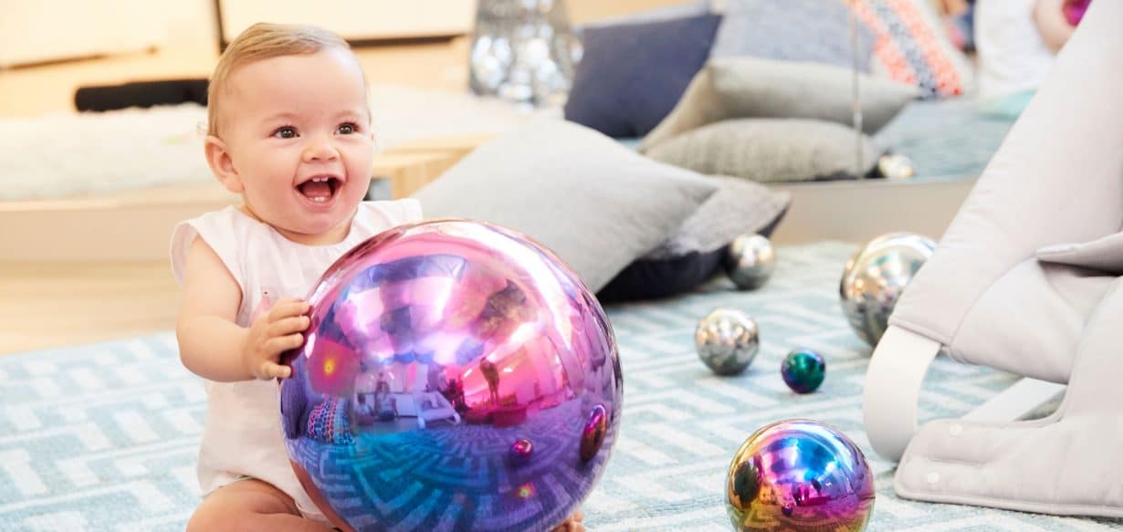 baby playing with reflective ball at Richmond childcare