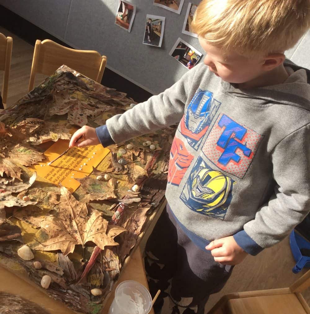 Child playing with leaves