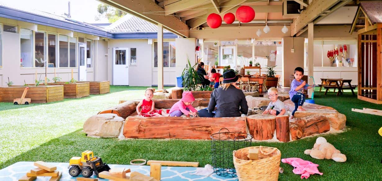 children and Educator sitting in outdoor area at Guardian Mentone East