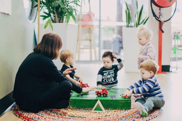 Educator playing with babies and infants