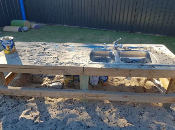 outdoor sink and sandpit as part of sustainability program