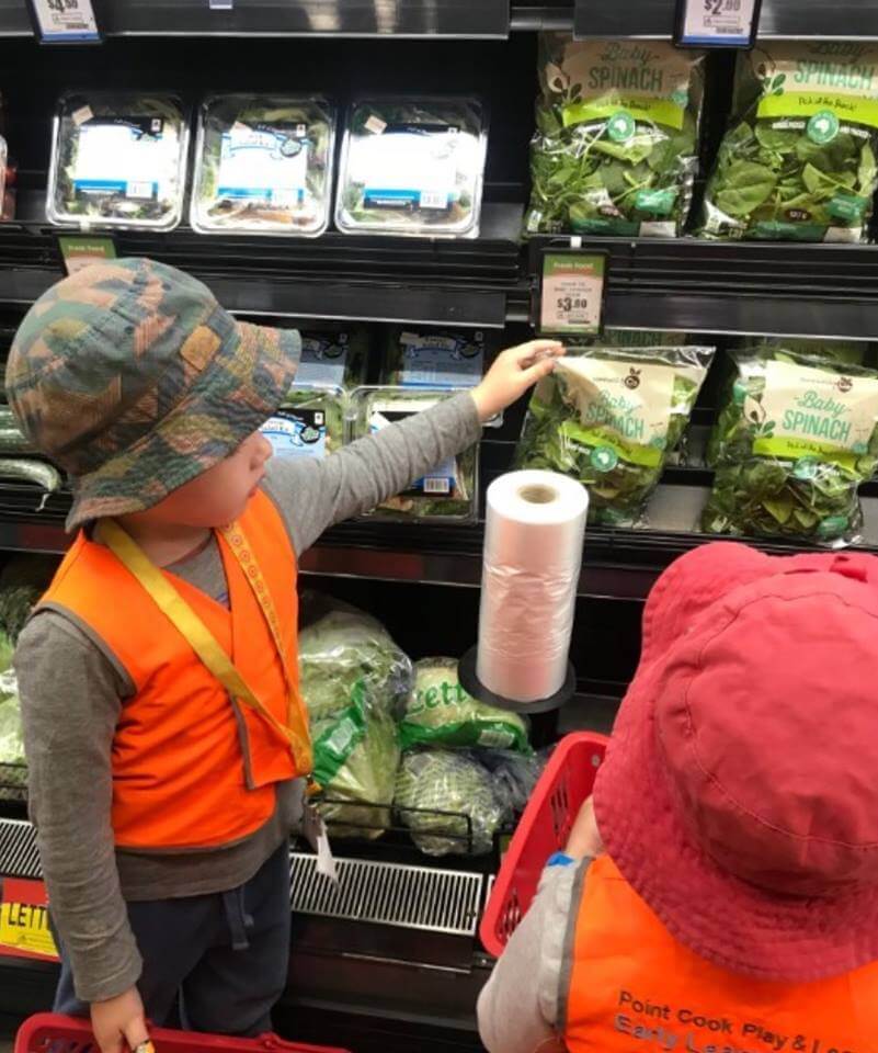 children at a grocery store on an excursion buying salad