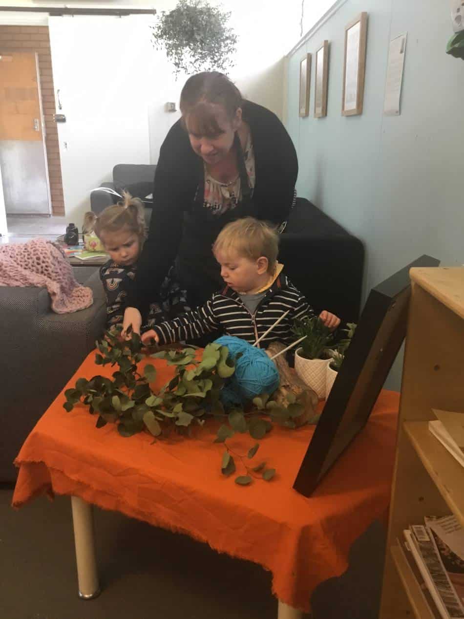 educator teaching young children to knit and about yarn bombing