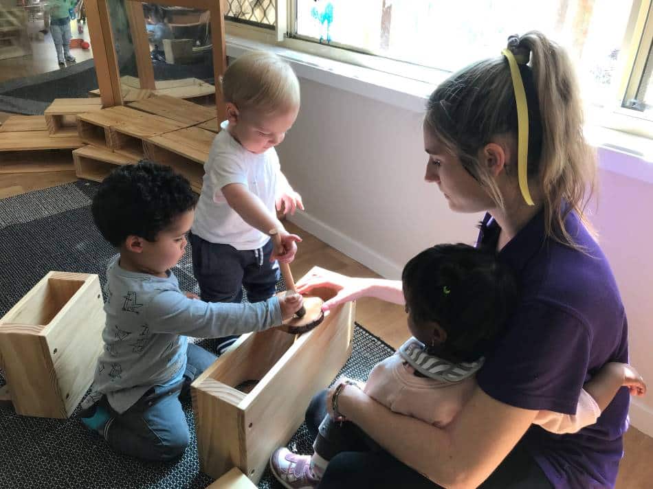 babies and Educator playing in new cot room