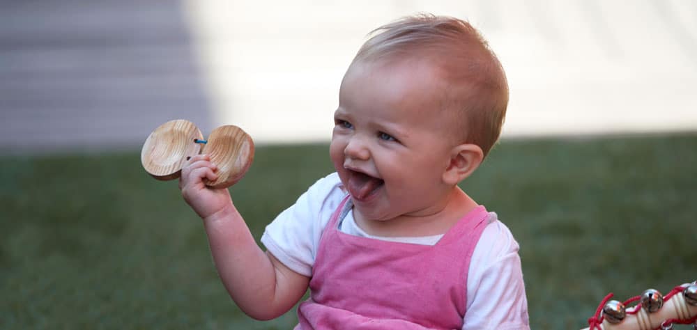 babies playing with musical instruments outside