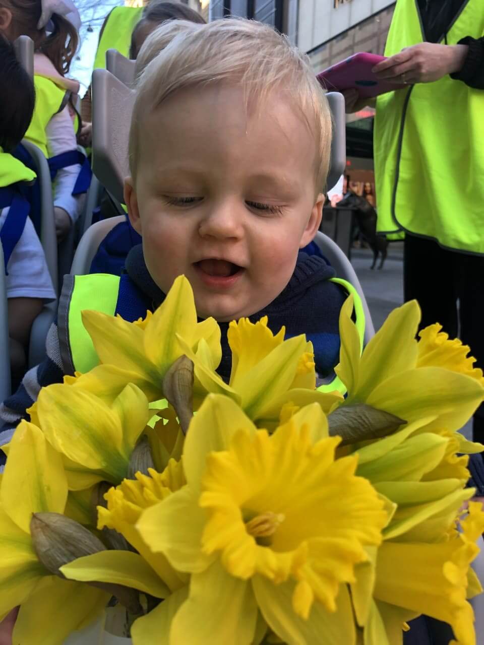 baby holding daffodils on Daffodil Day