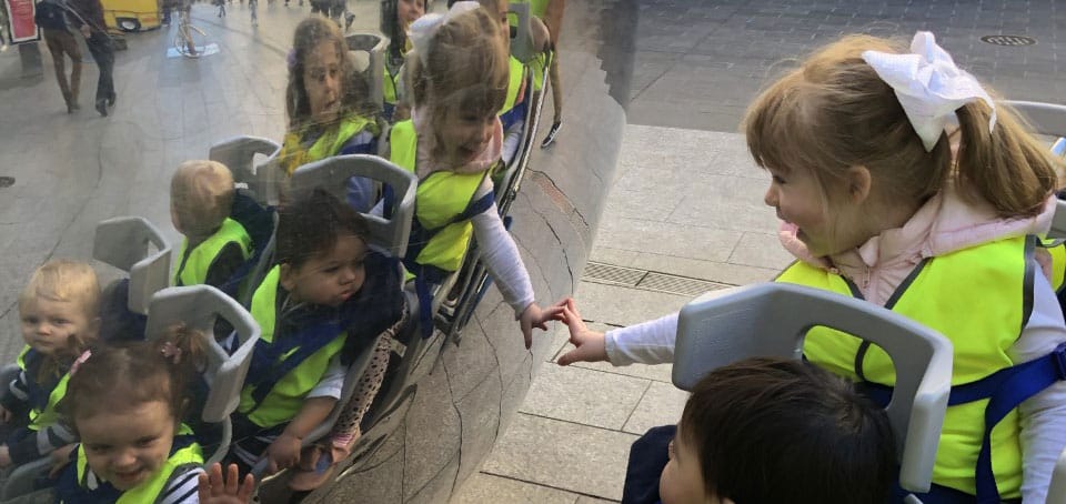 children looking in reflection of ball on Daffodil Day