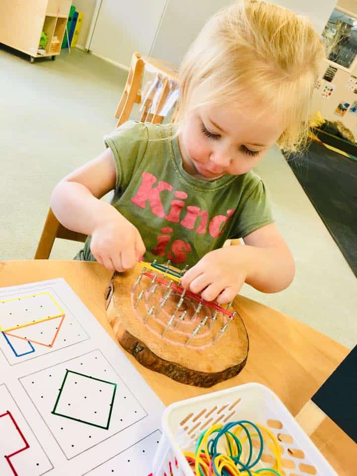 child building geoboards at Eastwood