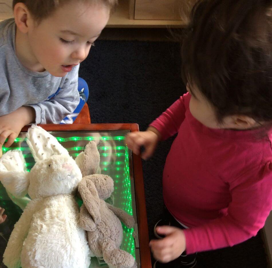 children trying to put teddies in infinity table