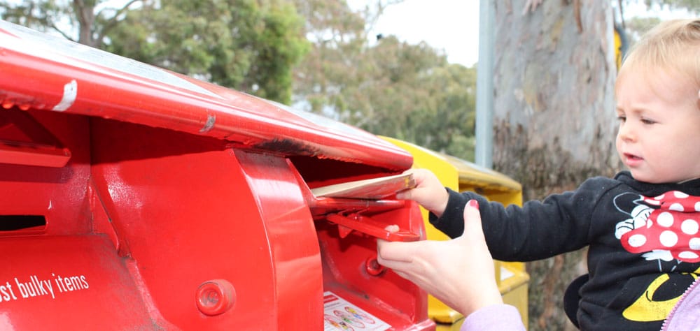 child putting letter in mailbox at excursion