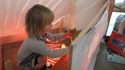 child playing with shadows and light in storytelling space