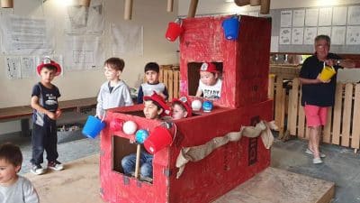 children build fire truck out of recycled materials at River Garden