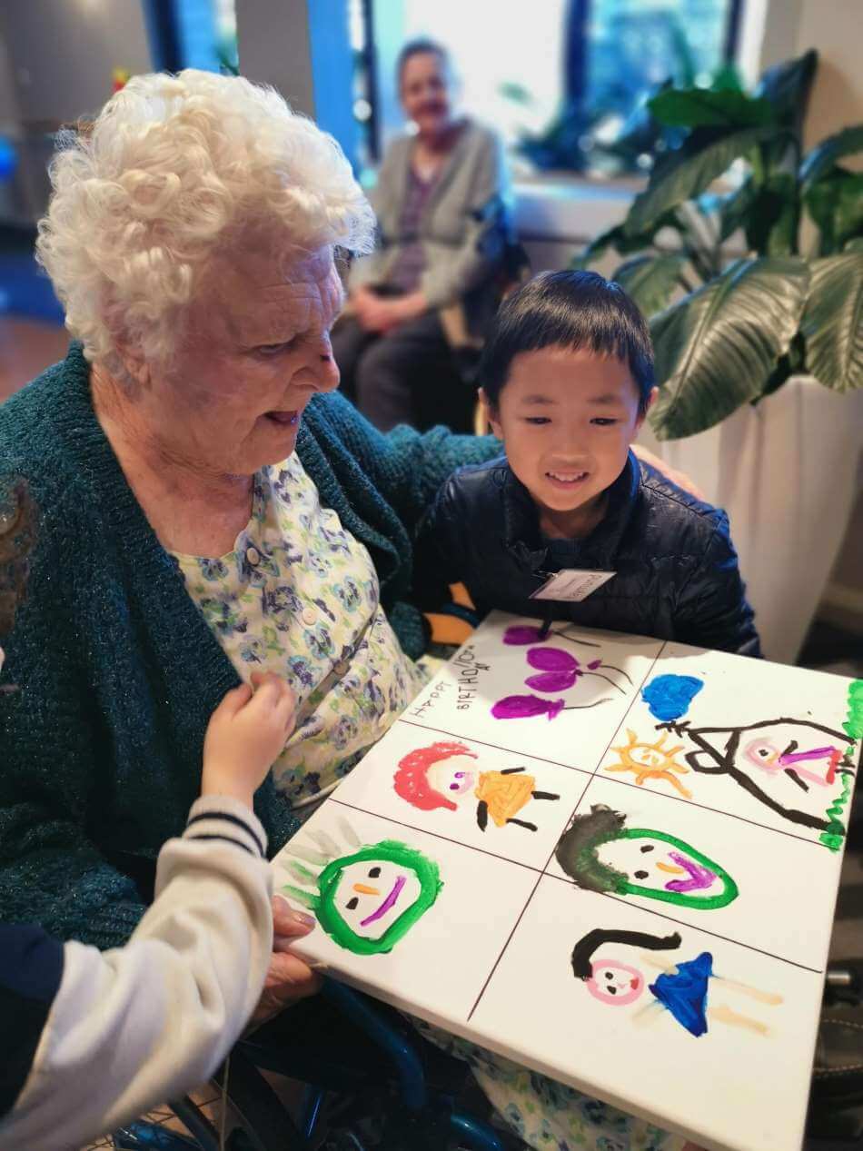 child from Guardian Sunnybank and resident at playgroup looking at drawings