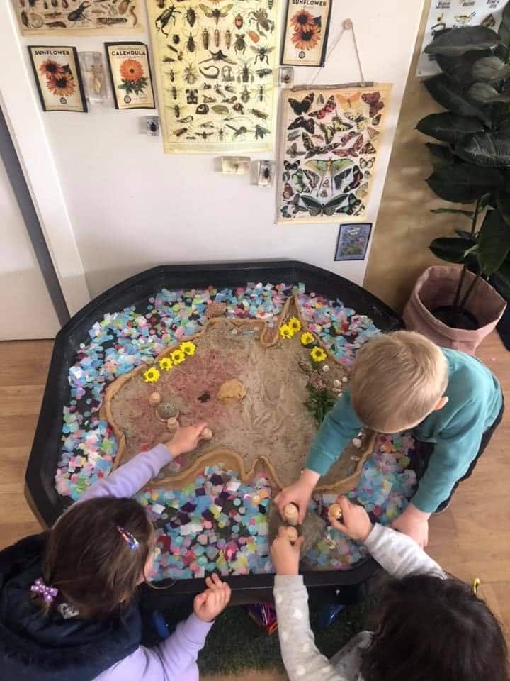 Three children learning about map of australia