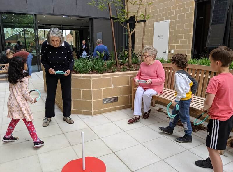 children and residents playing at intergenerational program