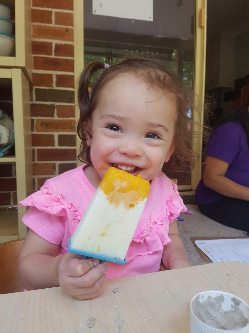 child eating ice blocks