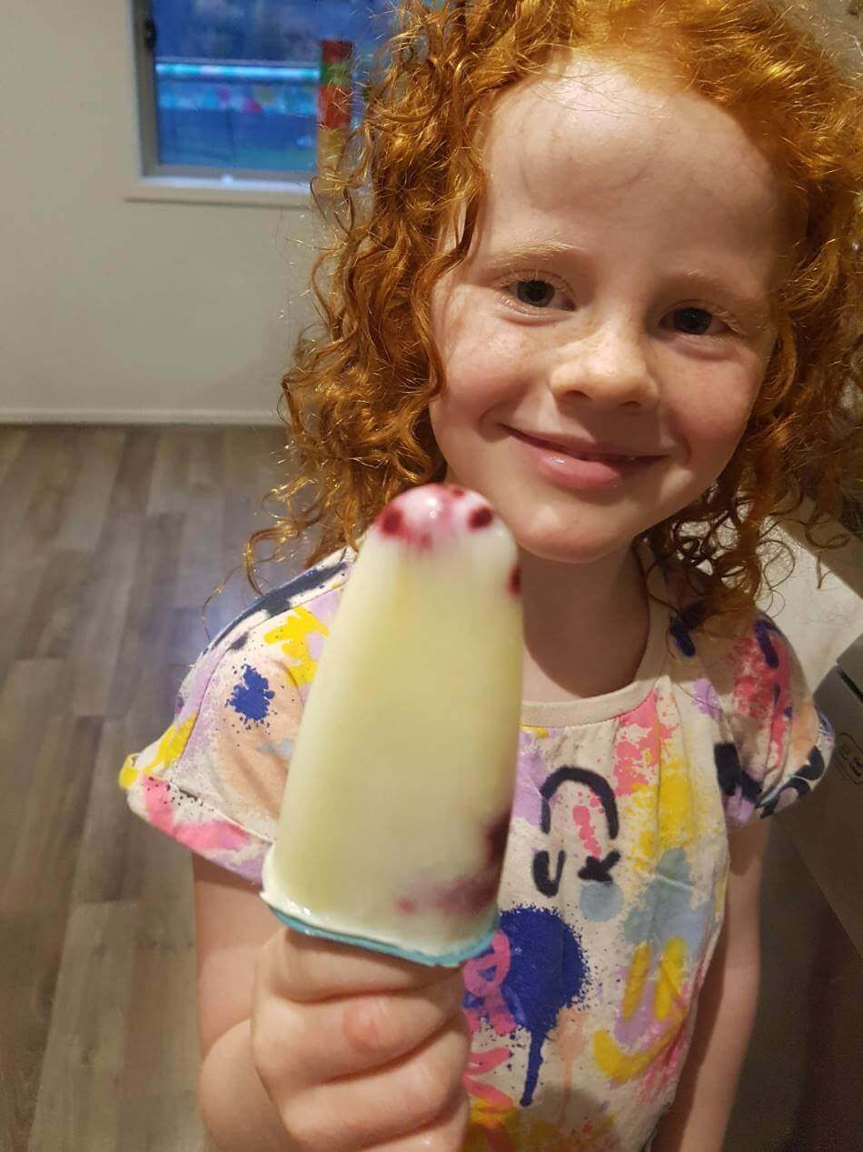 child holding homemade ice block