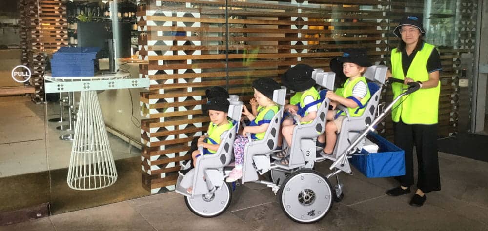 children in octo pram on excursion to collect recycled materials from Guardian Queen Street