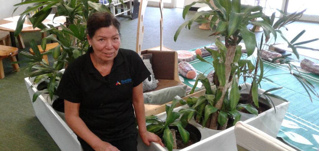 Educator at Guardian Balmain Cove in front of plants