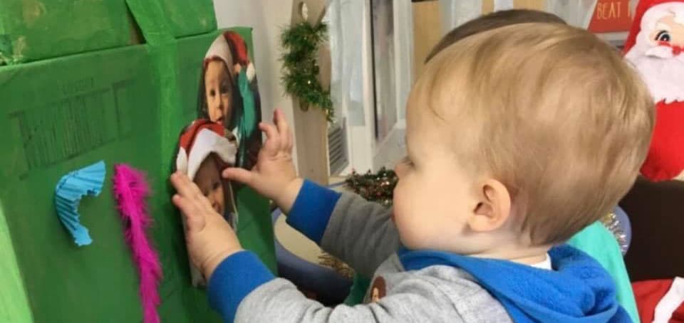 toddler decorating Christmas tree