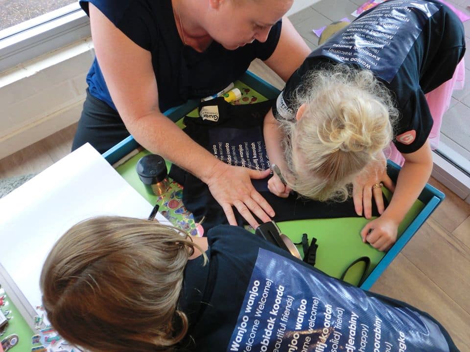 Guardian Clayfield children signing a tshirt at Graduation