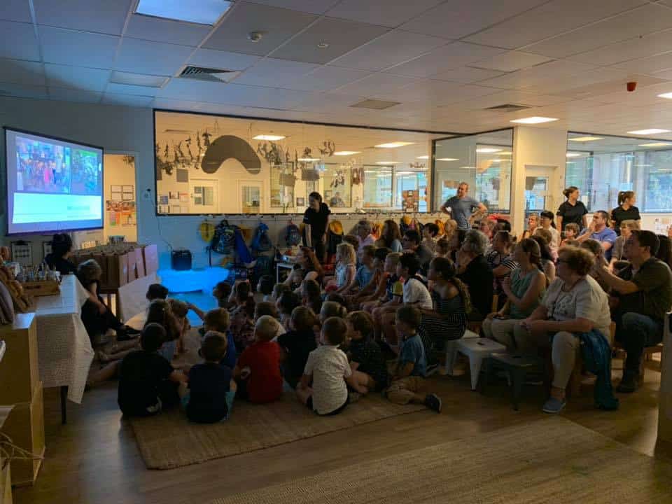 children and families watching graduation video