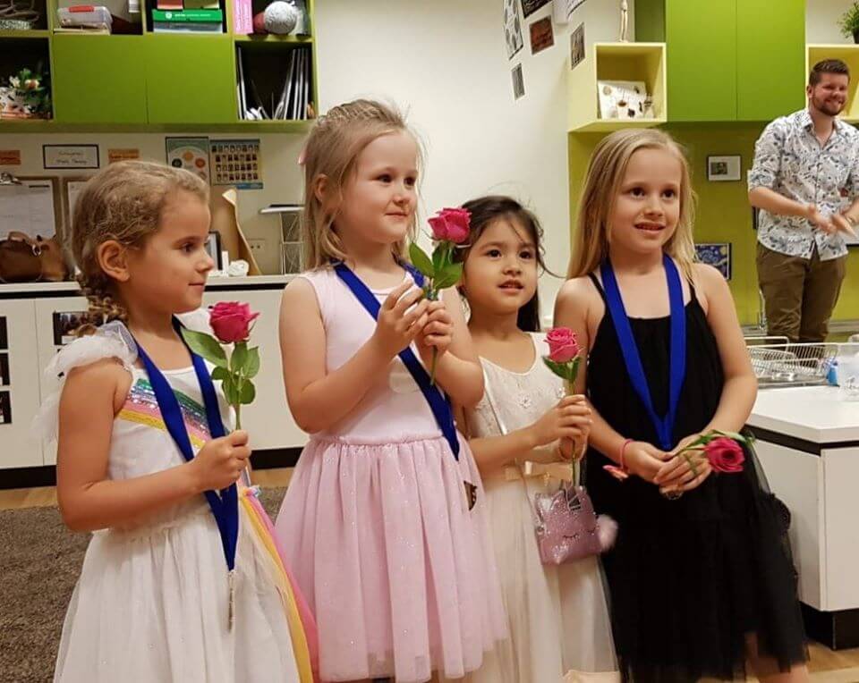 Children holding folders at Graduation ceremony