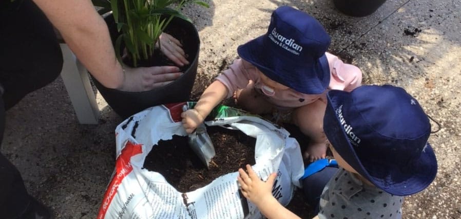 children potting plants for Guardian Croydon Park