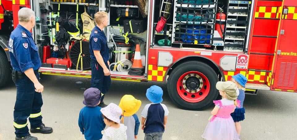 firefighters from Eastwood Fire Station showing children fire truck