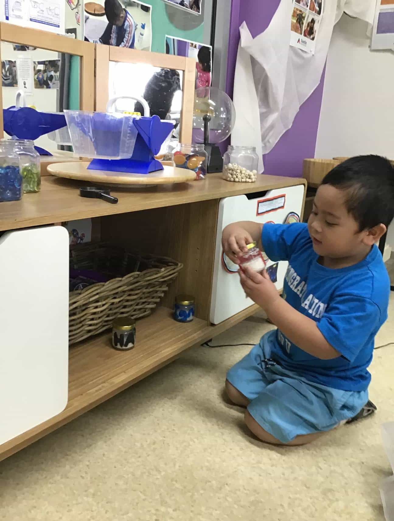 child speaking to jar as part of experiment