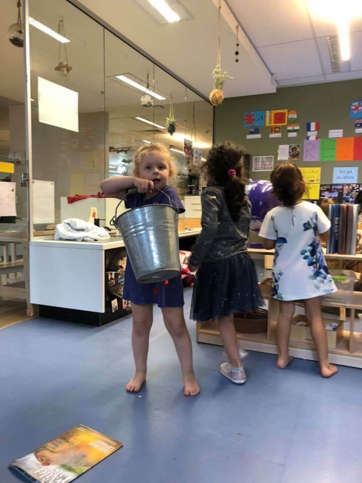 children holding bucket after reading 'Have You Filled Your Bucket Today?'