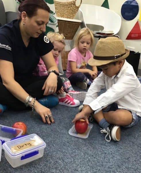 children helping cut apples for growing germs experiment