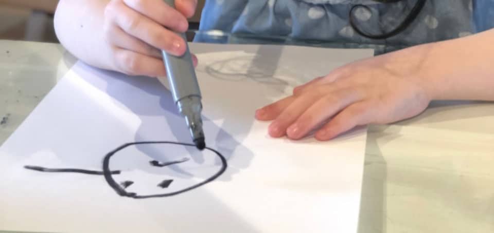child drawing self-portrait for wishes installation