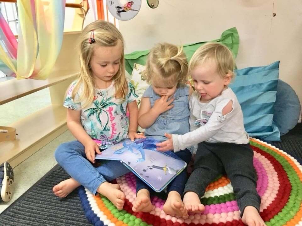 preschool child reading to younger children in leadership program