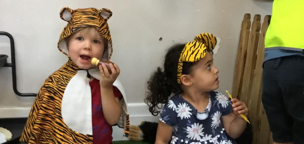 children dressed as tigers in sociodramatic play space