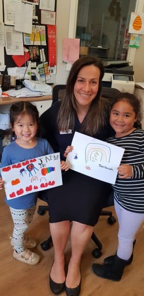 children and Centre Manager holding letters for friends at home